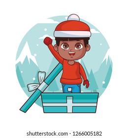 Boy with winter clothes inside gift box