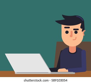 boy working on laptop sitting at desk, green background