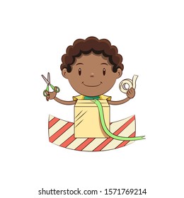 Boy wrapping a gift, happy cute child