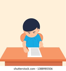 A boy writing school test in a classroom