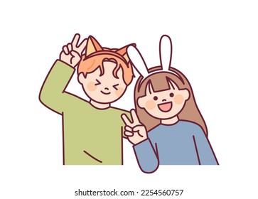 A boyfriend and girlfriend wearing cute animal headbands are taking pictures at a photo booth.