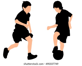 boys kicking football on the sports field