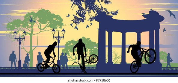 Boys on bicycles on the pavement background and walking people