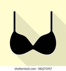 Bra simple sign. Black icon with flat style shadow path on cream background.