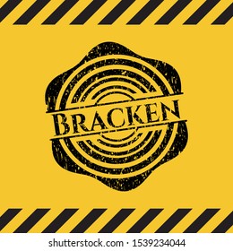 Bracken black grunge emblem inside yellow warning sign. Vector Illustration. Detailed.