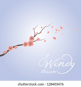 Branch of sakura tree blown by springtime wind in blue sky