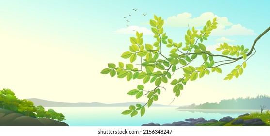 A branch of a tree with green leaves with a background landscape of rivers and mountains.