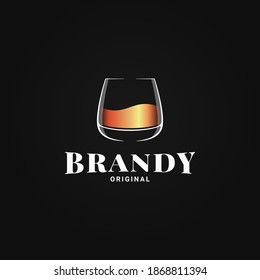 Brandy glass logo. Golden whiskey or cognac in glass on black background