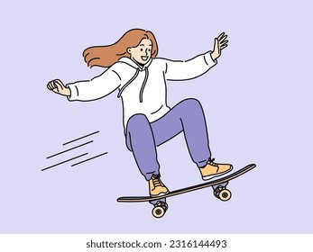 Brave girl skateboarder makes aerial stunt by bouncing on ramp in skatepark. Smiling young woman riding skateboard and enjoying extreme sports wanting to become professional skateboarder