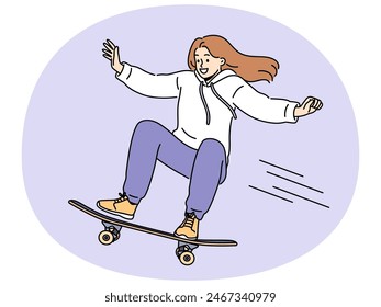 Brave girl skateboarder makes aerial stunt by bouncing on ramp in skatepark. Smiling young woman riding skateboard and enjoying extreme sports wanting to become professional skateboarder