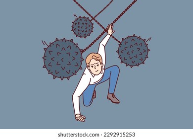 Brave man dodges prickly balls suspended from chain, symbolizing business problems and obstacles to success. Guy demonstrates leadership qualities by overcoming problems and adapting to situation