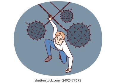 Brave man dodges prickly balls suspended from chain, symbolizing business problems and obstacles to success. Guy demonstrates leadership qualities by overcoming problems and adapting to situation