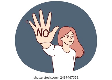 Brave woman makes stop gesture showing palm with inscription no to call for end to violence or discrimination. Woman feminist expresses denial and fights against discrimination or harassment