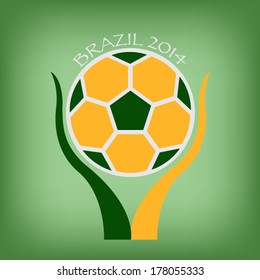 Brazil soccer in hand on green background