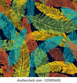 The Brazilian background from feathers in the Brazilian ethnic color. Seamless pattern. Carnival background on the dark.