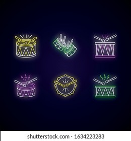 Brazilian music neon light icons set. Drums with drumsticks. Samba. Musical instrument. Brazilian carnival. Festive parade. Signs with outer glowing effect. Vector isolated RGB color illustrations