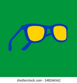 Brazilian sun glasses in national colors, yellow, blue on green background