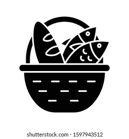 Bread and fish in basket glyph icon. Feeding the multitude. Holy week. Blessing food from Bible. New Testament. Bible narrative. Silhouette symbol. Negative space. Vector isolated illustration