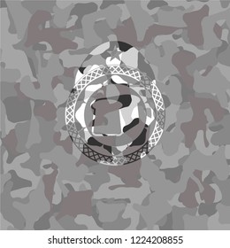 bread icon inside grey camouflaged emblem