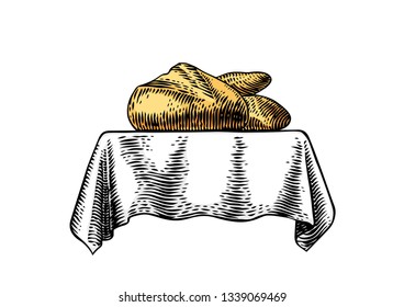 Bread and white loaf on the white tablecloth