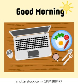 Breakfast before work and laptop on a wooden table with the words "Good morning" on it