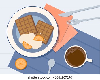 Desayuno. Copa de café y gofres belgas con crema y naranja. 