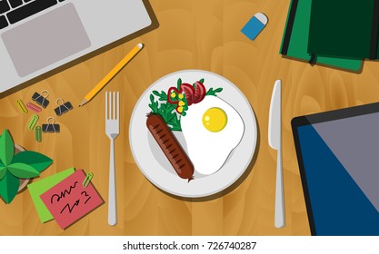 Breakfast first concept, Top view of working desk with plate of breakfast (fried egg with sausage),  laptop, mobile phone, and notebook 