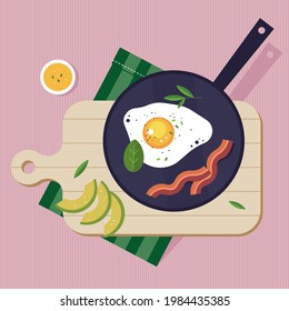 breakfast in a frying pan early in the morning scrambled eggs with bacon and avocado