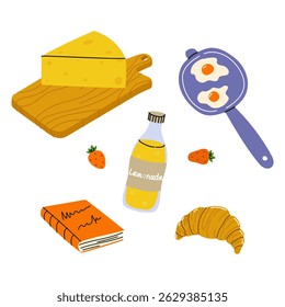 Breakfast items arranged with cheese, eggs, croissant, lemonade, and a notebook on a wooden board