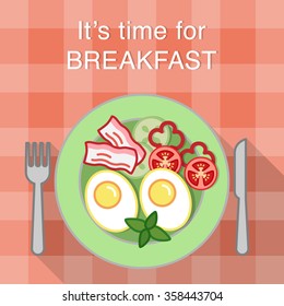 Breakfast table with fried eggs, bacon and vegetables on a plate, knife and fork