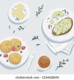 Breakfast top view. Cup of tea, lemon wedges, pancakes with fresh berries, toast with avocado. Healthy food. Restarant menu design. Scandinavian style