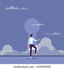 Breaking through to freedom Concept-Businessman escaping through the fence