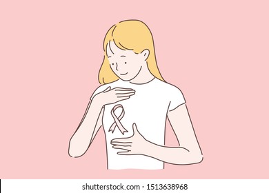 Breast cancer, awareness month concept. Womens day October 15 fight the disease. A young woman or girl smiling looks at a pink ribbon symbol. A lady with cancer doesnt fall in spirit. 