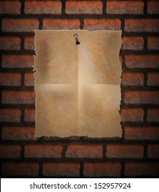 Brick background and old paper sheet nailed
