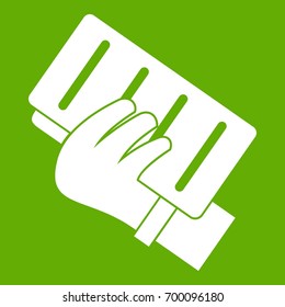 Brick in a hand icon white isolated on green background. Vector illustration