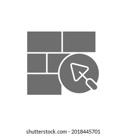 Brick wall with putty knife, repair bricklaying, construction grey icon.