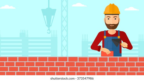 Bricklayer with spatula and brick.