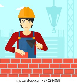 Bricklayer with spatula and brick.
