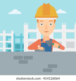 Bricklayer with spatula and brick.