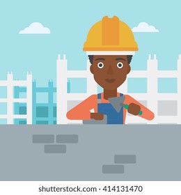 Bricklayer with spatula and brick.