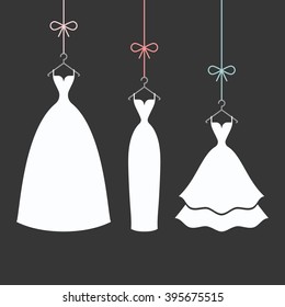bridal dresses white on a hangers on the black background