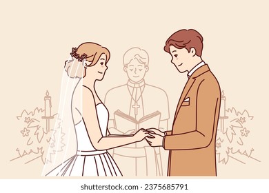 Bride and groom on altar, hold hands and listen to speech of priest during wedding ceremony in church. Wedding ceremony with man and woman, want to create new family for living together