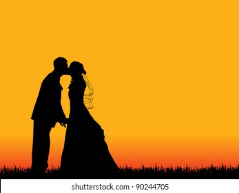  bride   groom silhouette kissing in  beautiful orange  red sunset sky as background