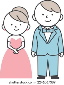 Bride and groom at wedding. Groom in tuxedo and bride in pink dress standing side by side.