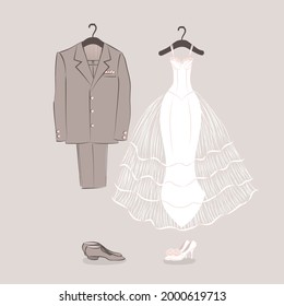 Bride's dress and groom's suit on hangers