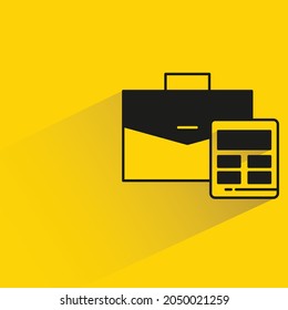 briefcase and calculator with shadow on yellow background