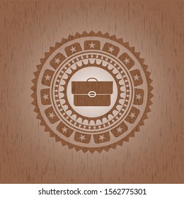 briefcase icon inside badge with wood background