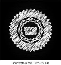 briefcase icon inside chalk emblem written on a blackboard