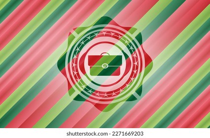 icono de maletín dentro del emblema de los colores de navidad. 