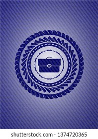 briefcase icon inside emblem with denim texture